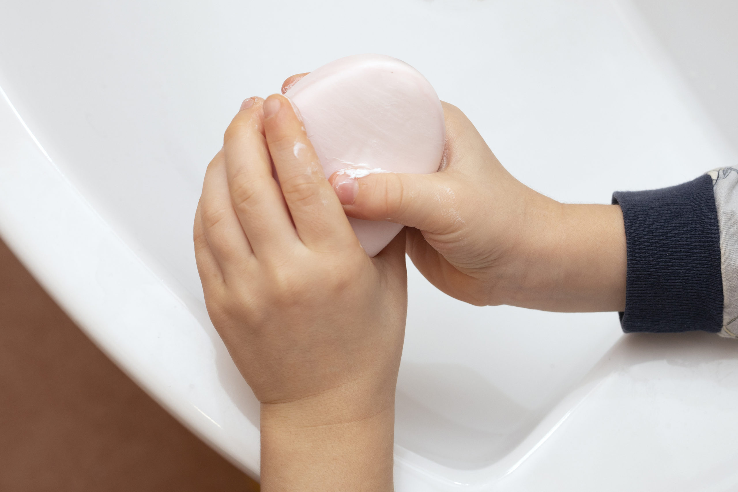 child washes, cleans hands with soap. Hygiene concept.
